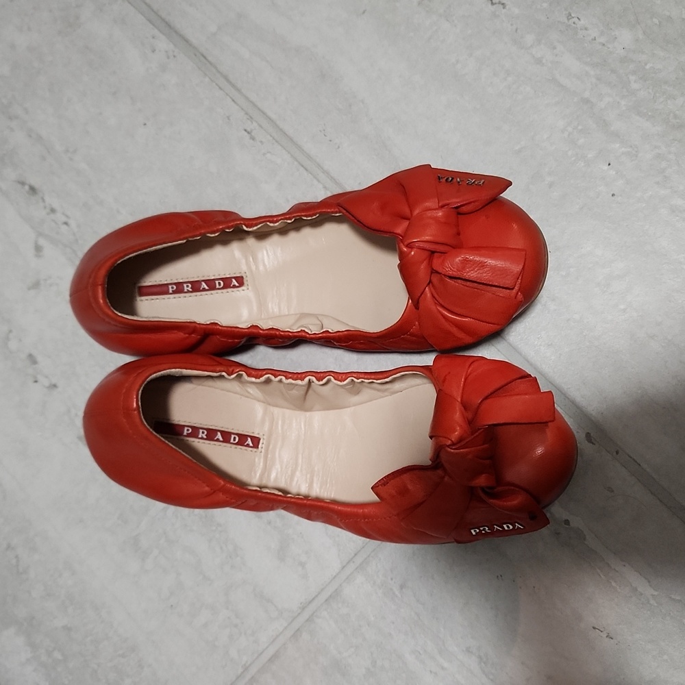 Red Prada flats with bow